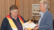 Ann Hunt, with brightly colored stole, receives Dual Covenant certificate from cathy knight