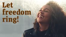 Black woman looking up at sunlit sky and smiling with joy; text says "Let freedom ring"