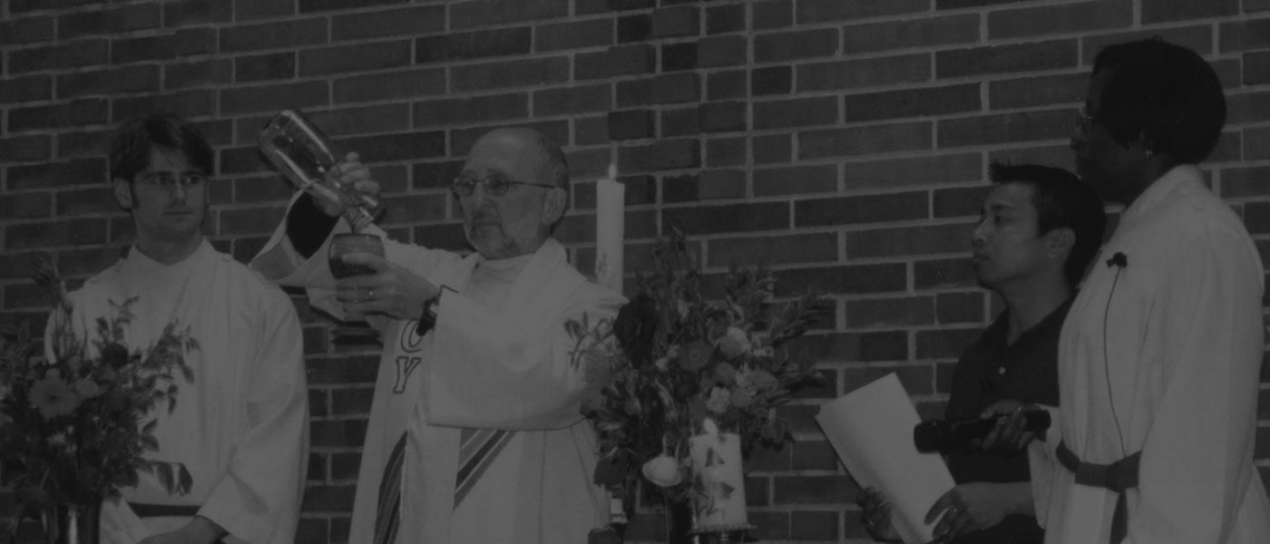 Greg Dell pouring communion wine